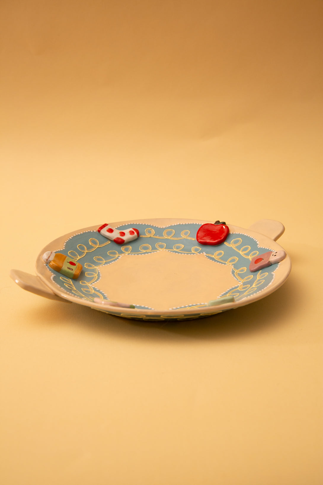 ceramic plate with colorful designs on a beige background