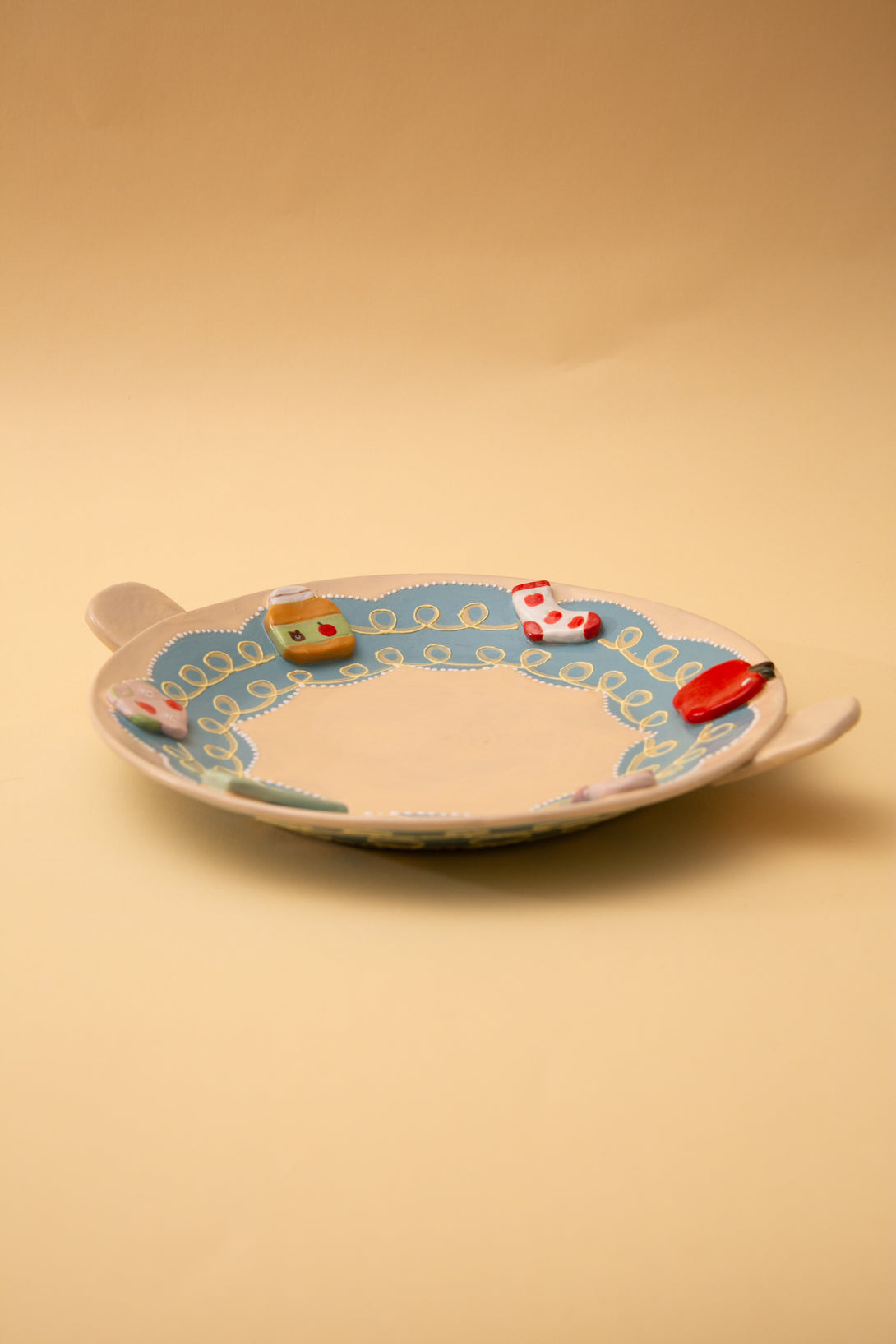 ceramic plate with colorful designs on a beige background
