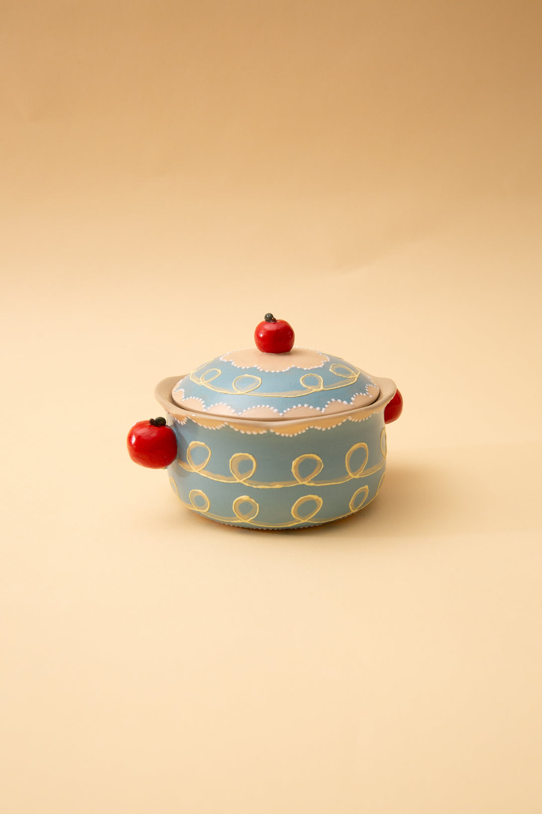 ceramic bowl with blue pattern and red accents on a beige background