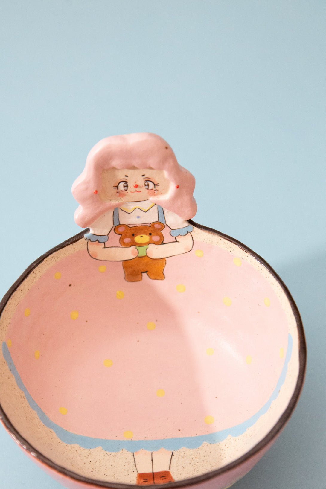 Ceramic bowl with a cartoon character on a light blue background