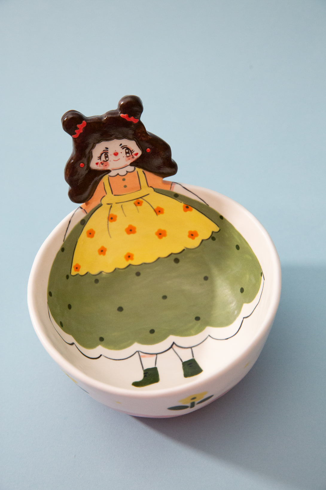 bowl with a cartoon character on a light blue background