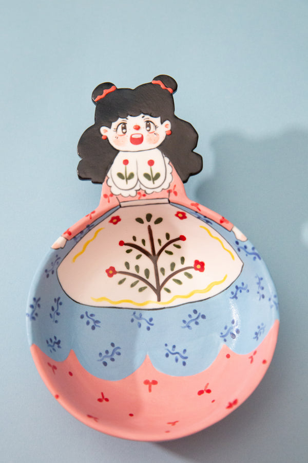 trinket dish with a cartoon character on a light blue background