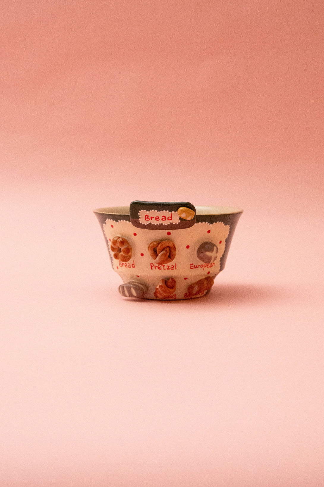 ceramic bowl with floral pattern on a pink background