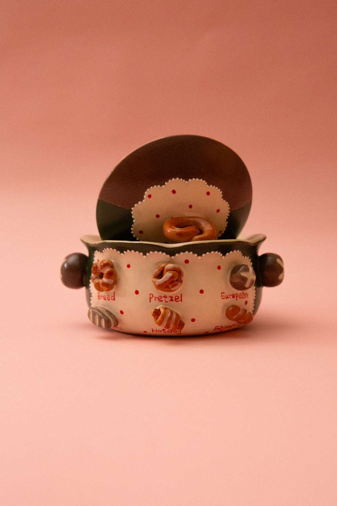 ceramic bowl with a design of donuts on a pink background