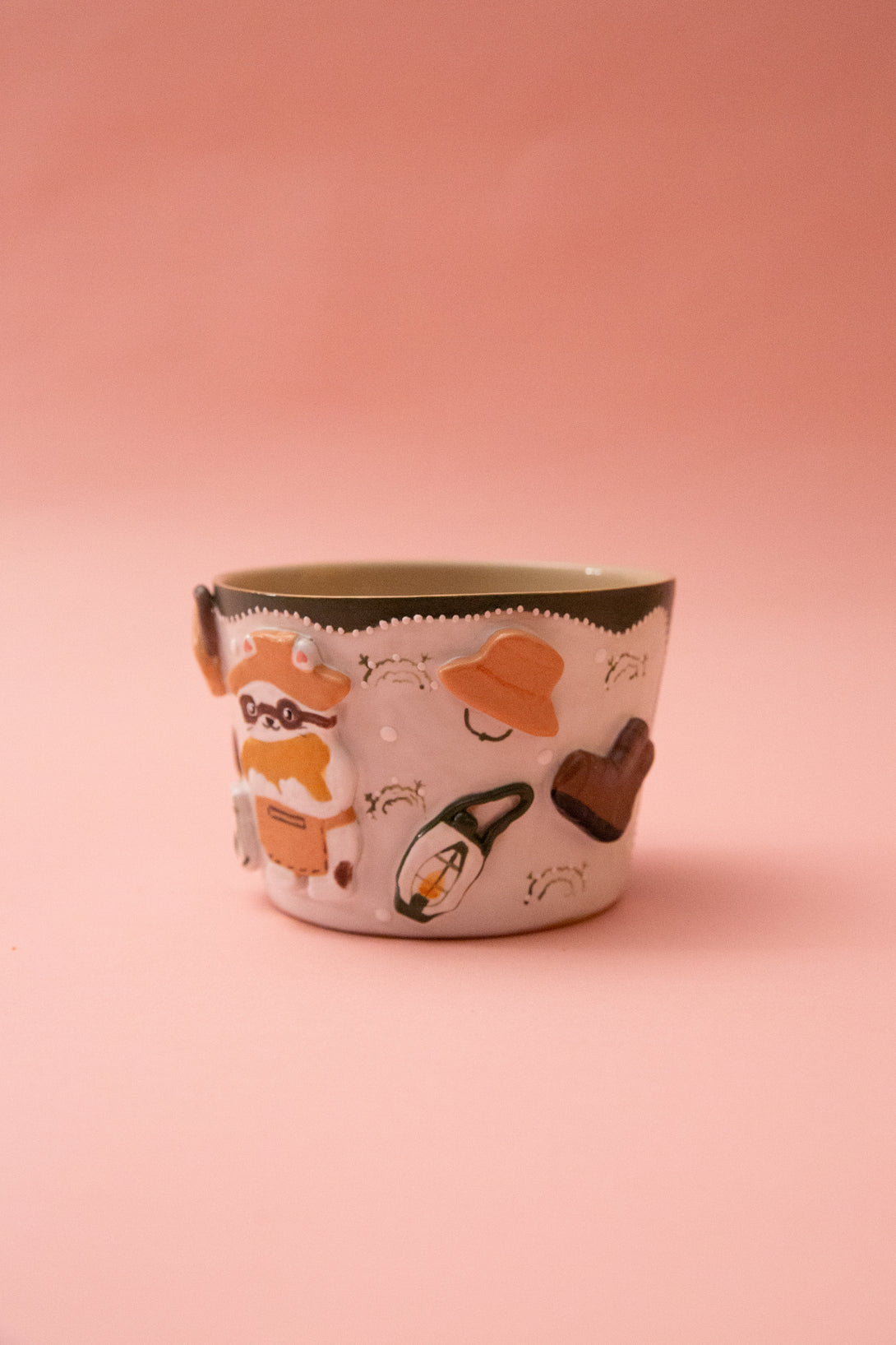Ceramic mug with illustrations on a pink background