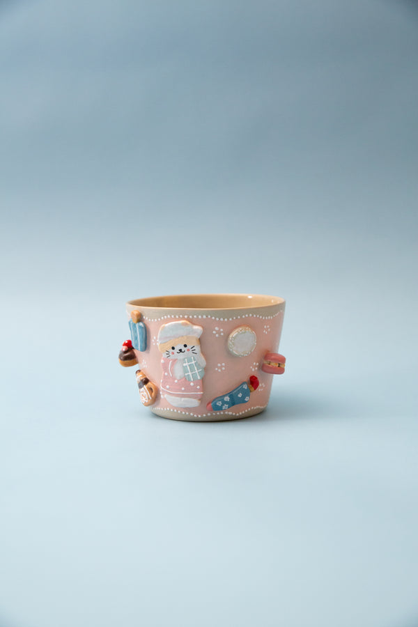 Pink cup with cartoon character on a light gray background