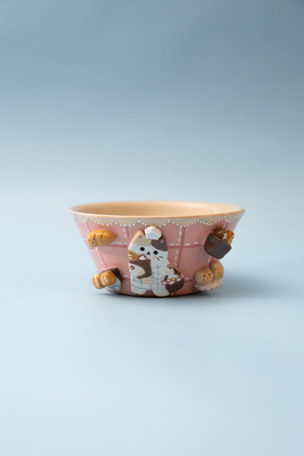 Ceramic bowl with cat illustrations on a light gray background