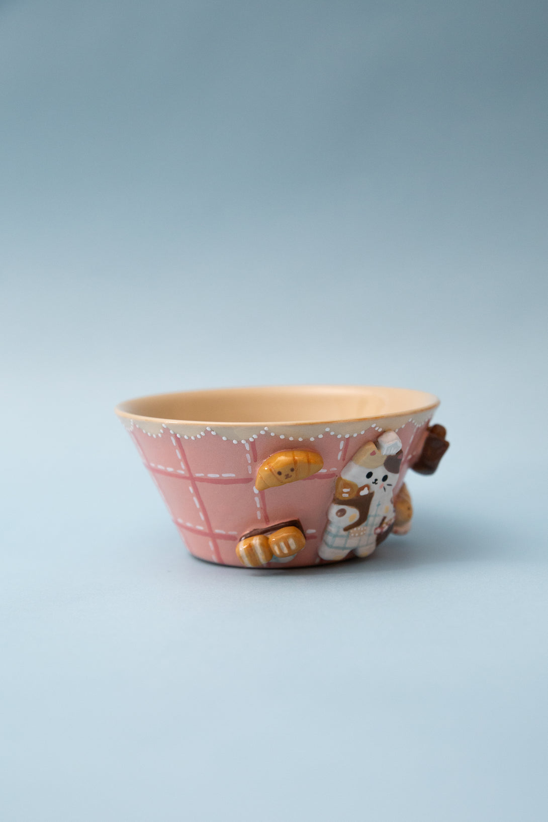 Ceramic bowl with cartoon character design on a light blue background