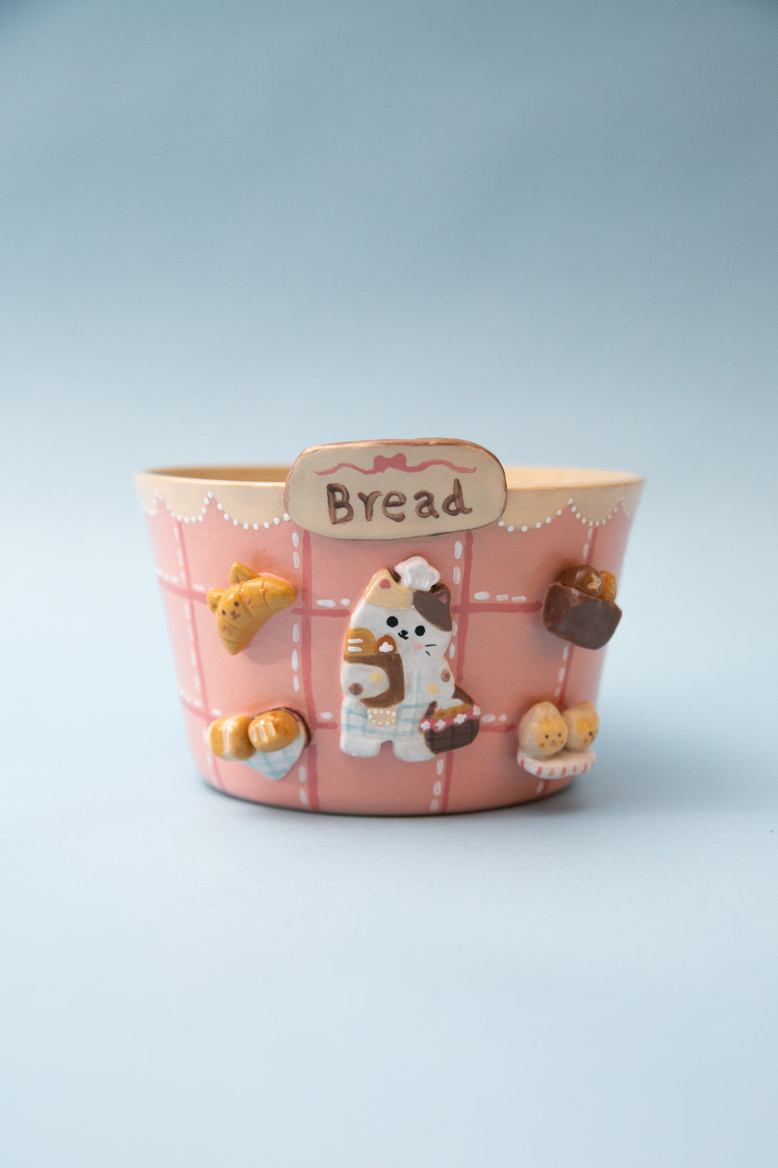 Ceramic ramen bowl with a cat design on a light blue background