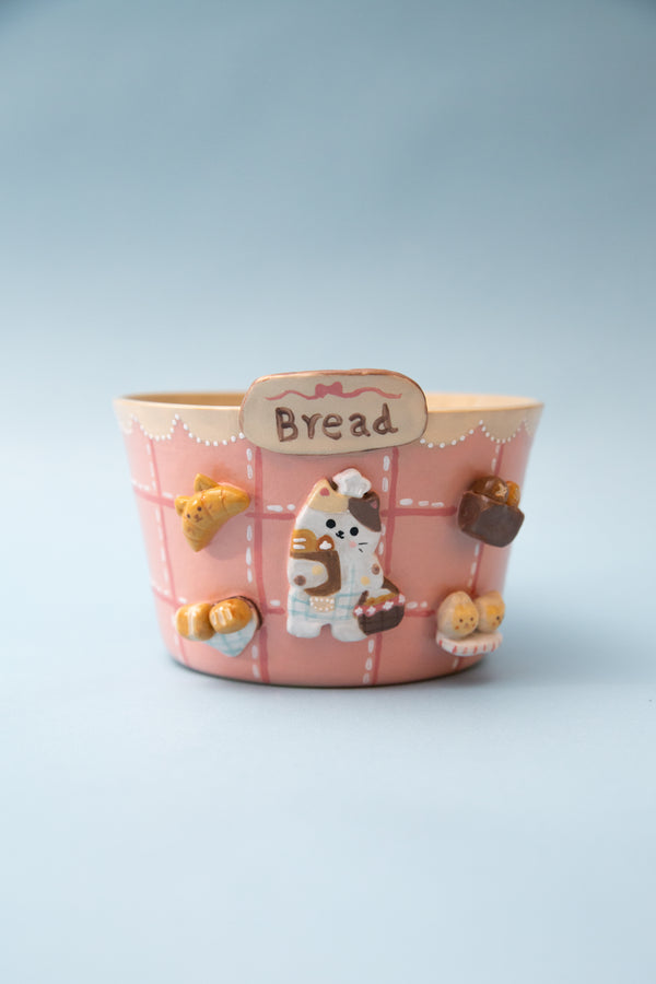 Ceramic ramen bowl with a cat design on a light blue background