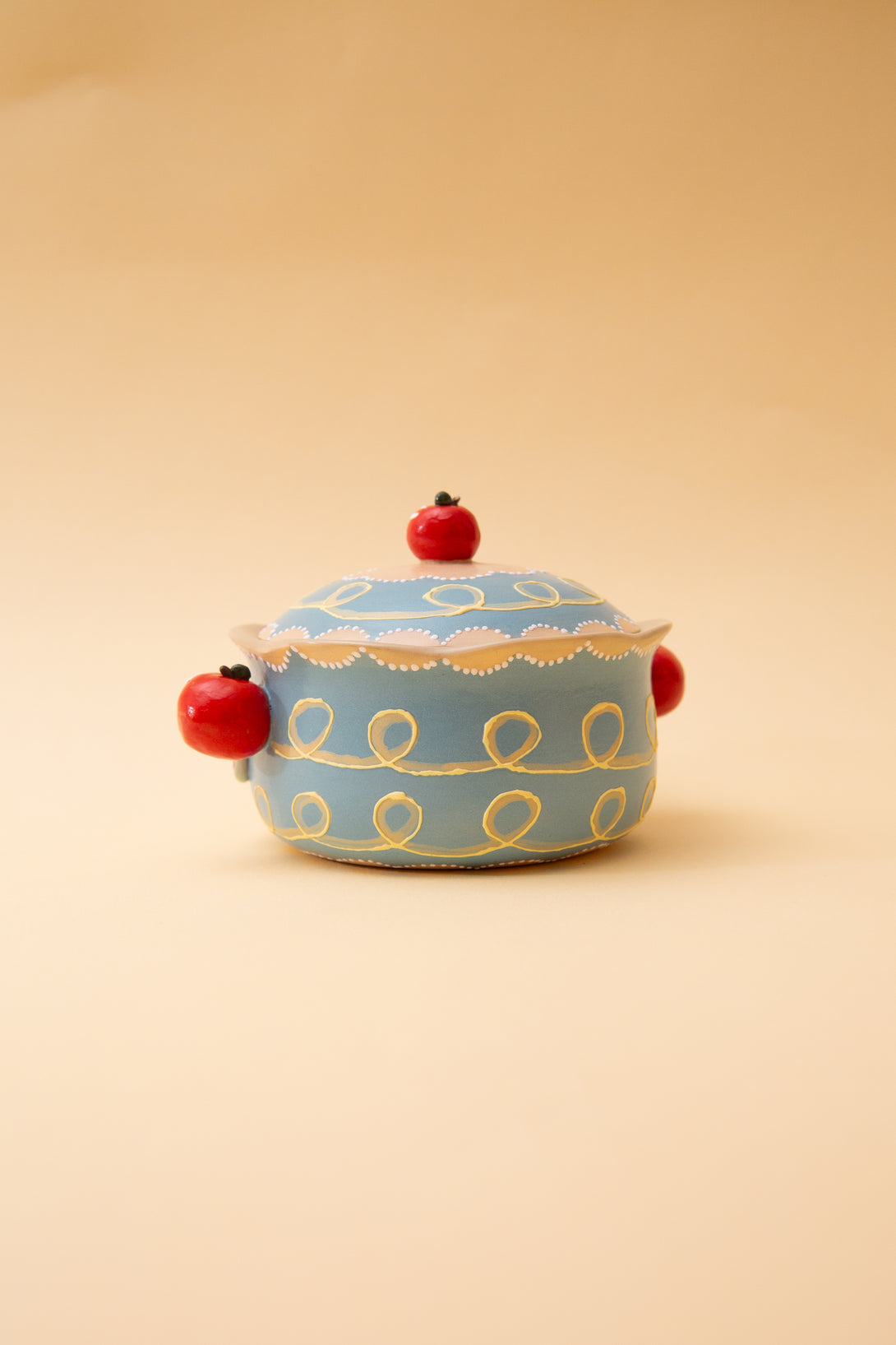 blue bowl with gold patterns and red accents on a beige background