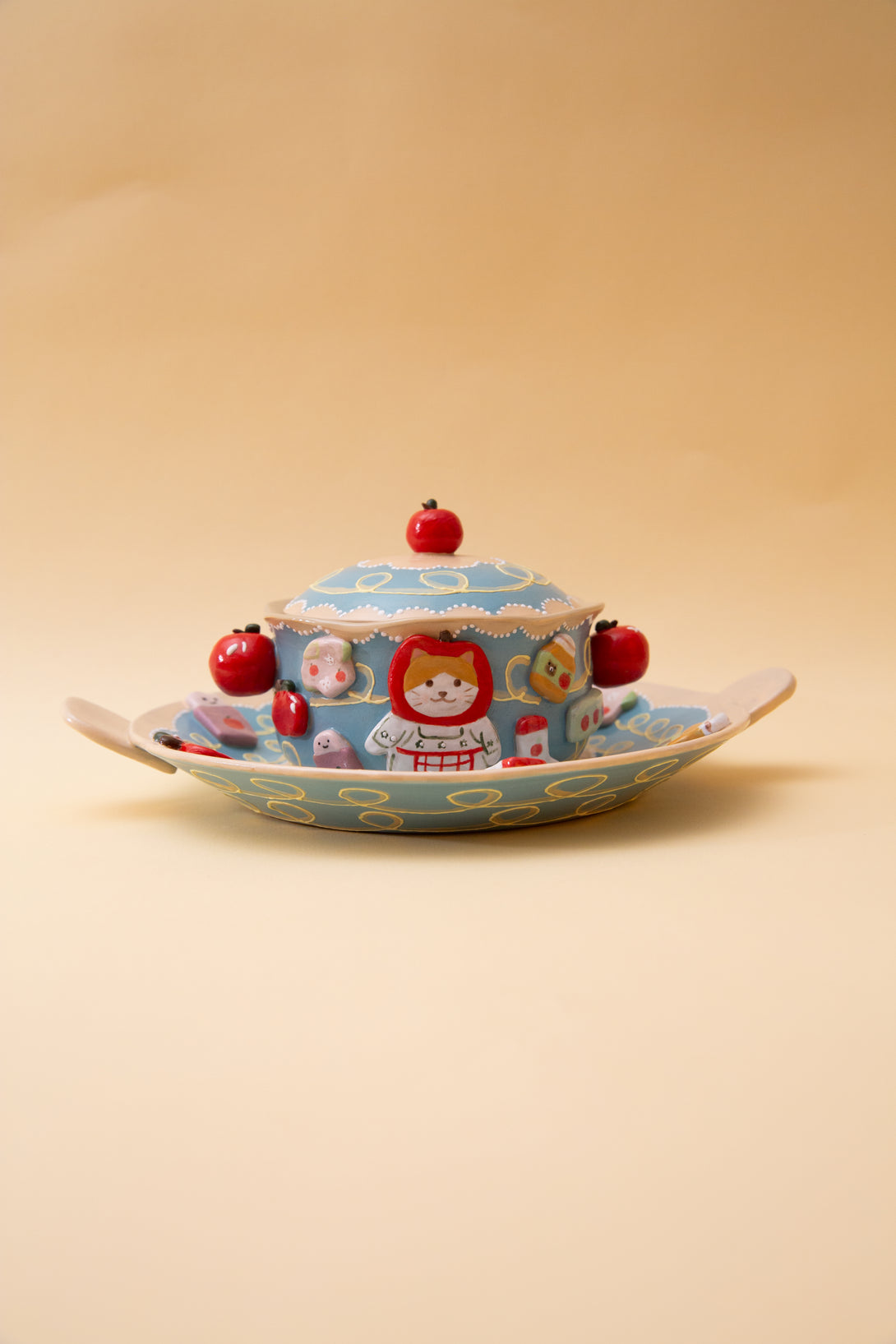 ceramic bowl with a lid featuring a cartoon character on a beige background