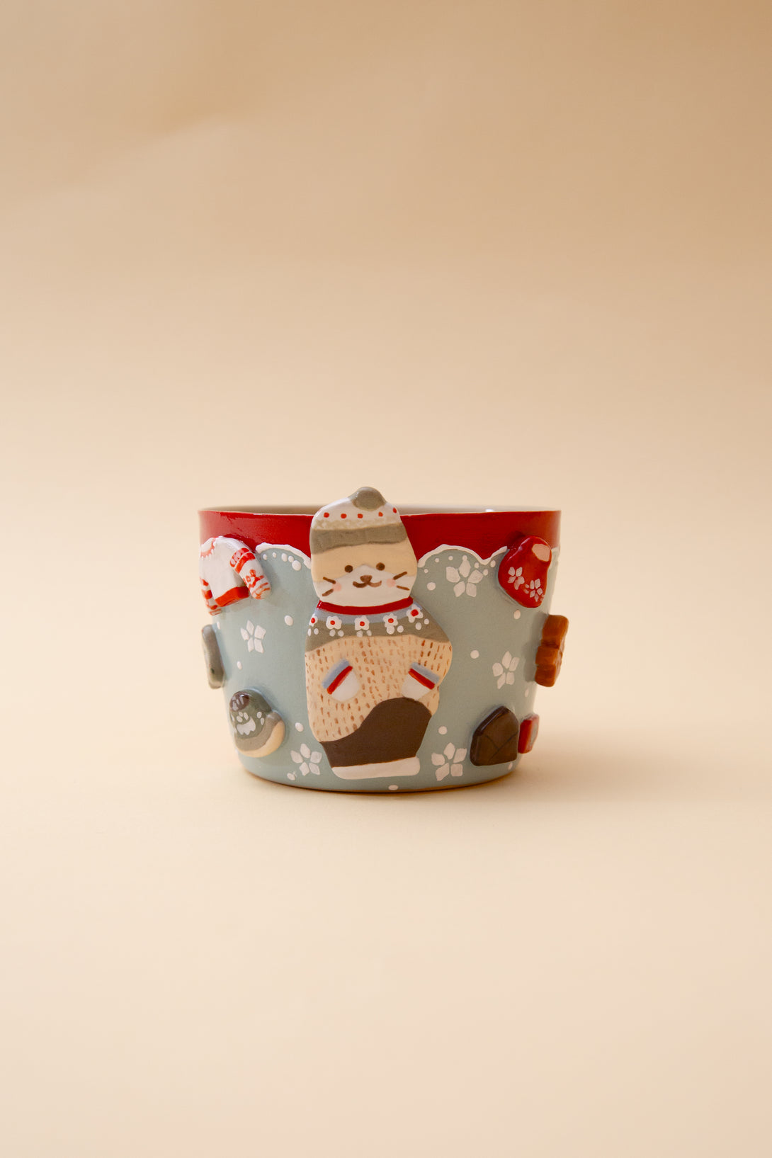 Cup with a Christmas theme featuring a cat design on a beige background