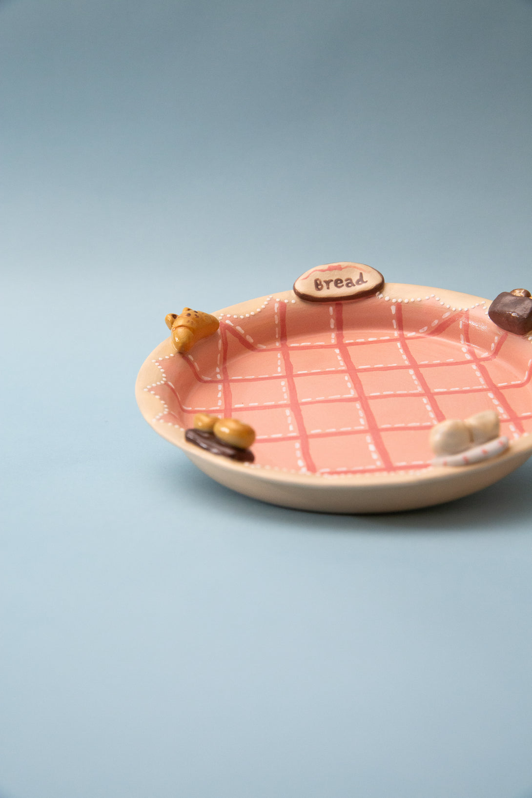 Ceramic plate with grid pattern on a light blue background