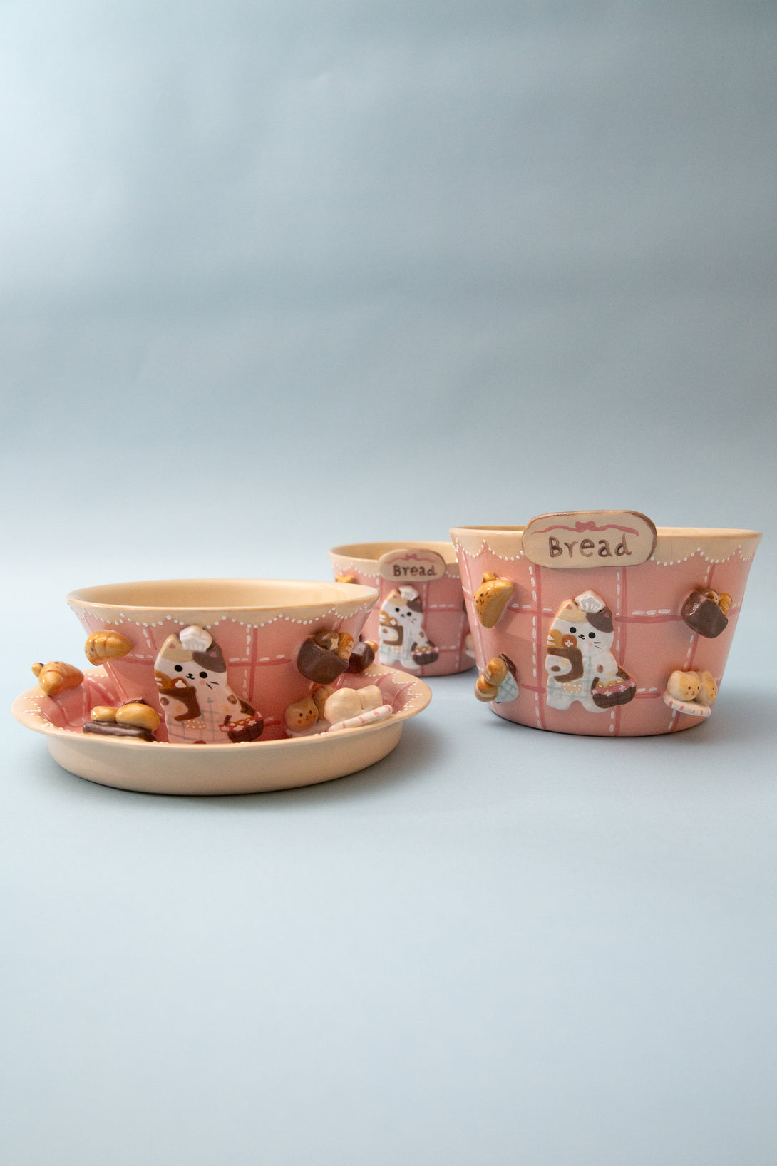 Set of ceramic bowls with cartoon designs on a light gray background